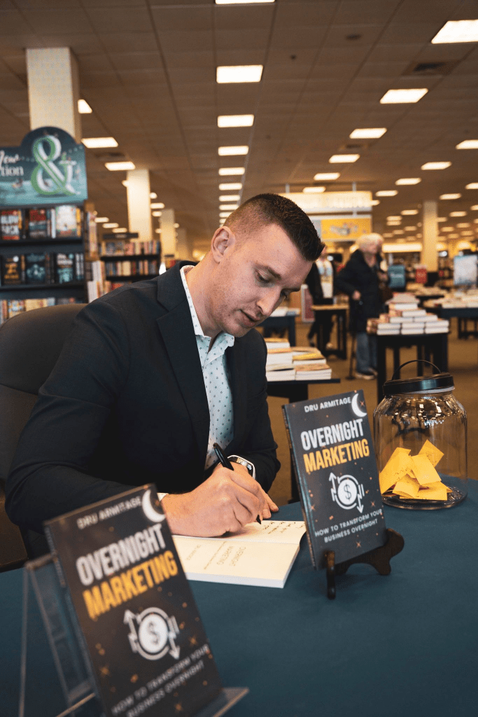 Dru Armitage is signing his book Overnight Marketing
